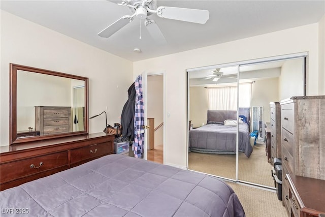 carpeted bedroom with ceiling fan and a closet