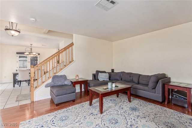 living room featuring an inviting chandelier and hardwood / wood-style flooring