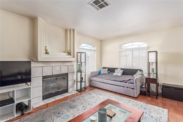 living room with wood-type flooring and a fireplace