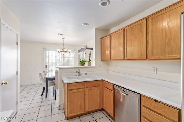 kitchen with light tile patterned flooring, sink, stainless steel dishwasher, kitchen peninsula, and an inviting chandelier