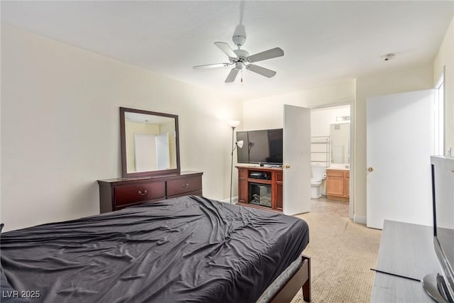 carpeted bedroom featuring ceiling fan and ensuite bath