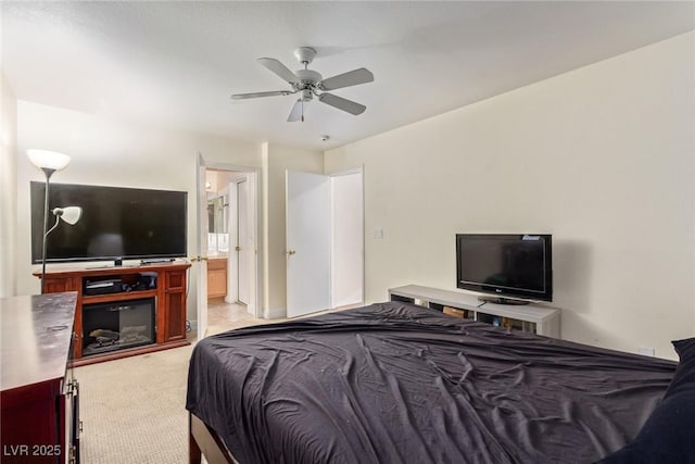 carpeted bedroom featuring ceiling fan and ensuite bathroom