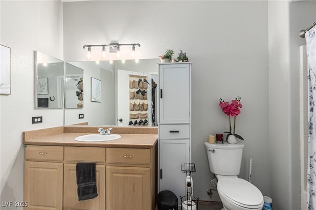 bathroom with vanity, a shower with curtain, and toilet