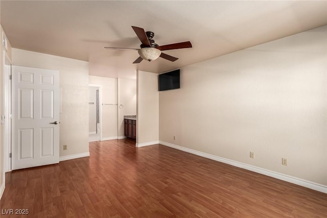 empty room featuring dark wood-type flooring and ceiling fan