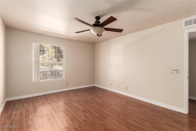 unfurnished room with dark wood-type flooring and ceiling fan