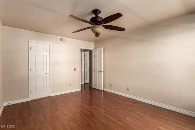 unfurnished bedroom featuring ceiling fan and dark hardwood / wood-style flooring