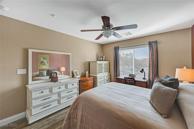 bedroom with dark wood-type flooring and ceiling fan