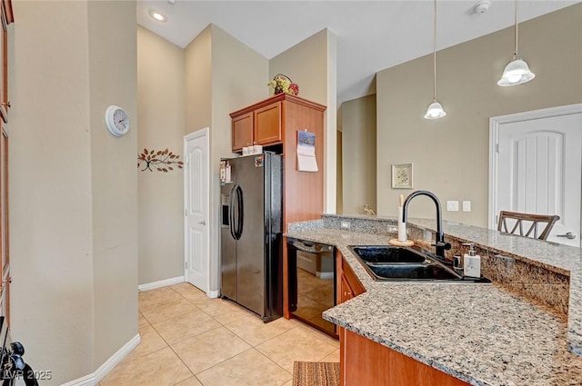 kitchen with light tile patterned flooring, decorative light fixtures, sink, black appliances, and light stone countertops