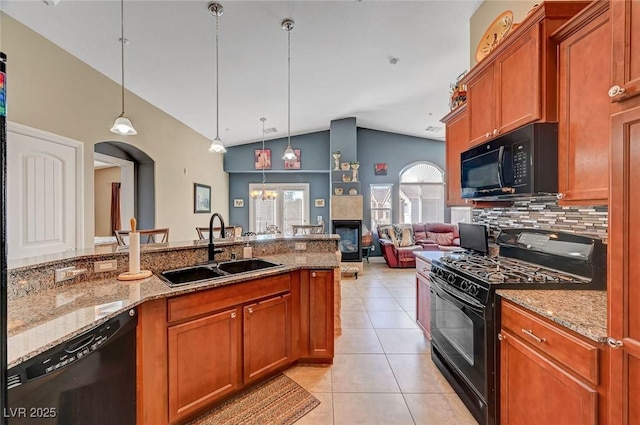 kitchen featuring pendant lighting, sink, light stone counters, black appliances, and light tile patterned flooring