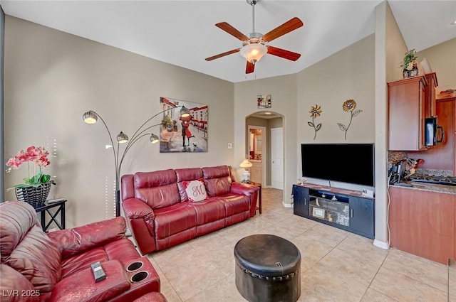 living room with vaulted ceiling, light tile patterned floors, and ceiling fan