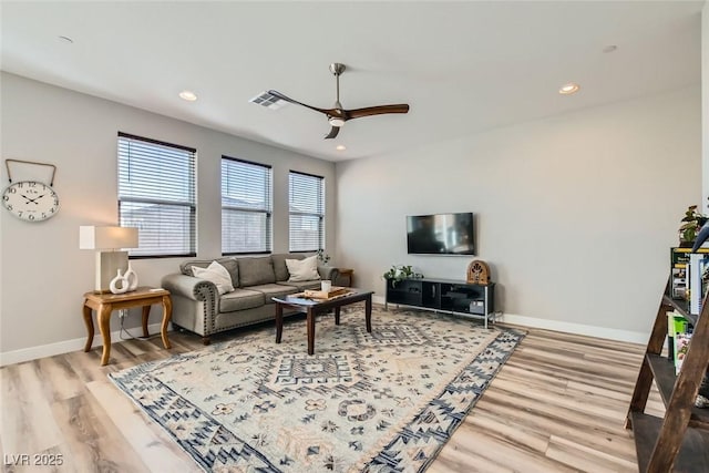 living room with ceiling fan and light wood-type flooring