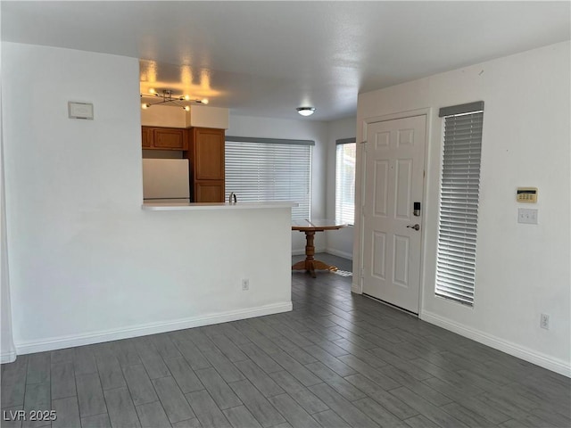 unfurnished living room featuring dark hardwood / wood-style flooring