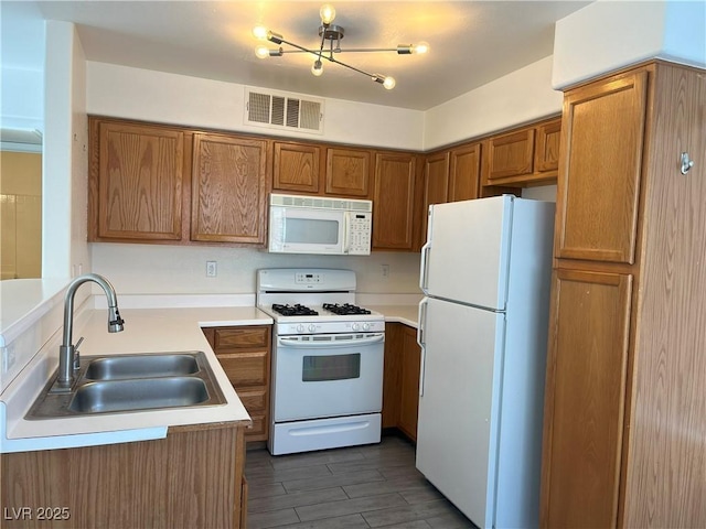 kitchen featuring sink and white appliances