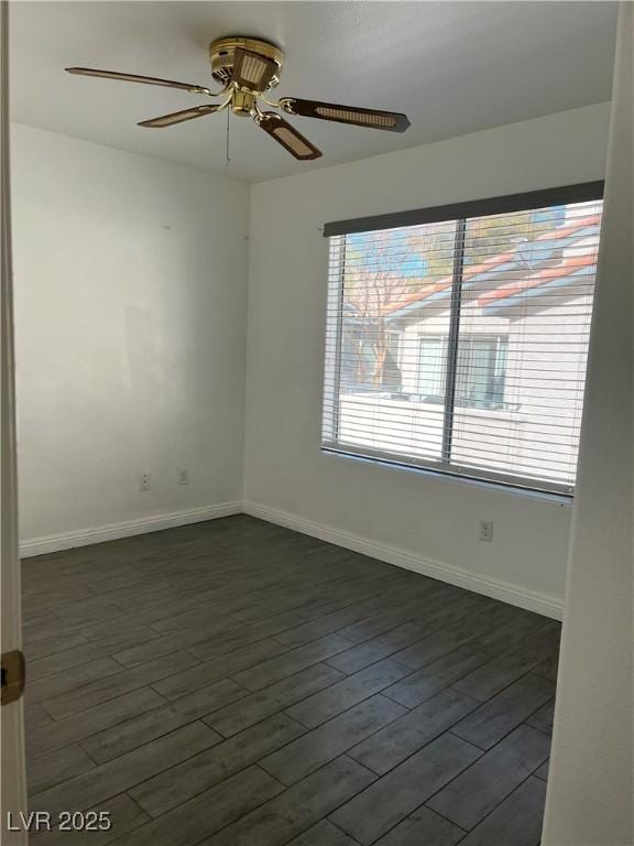 empty room featuring ceiling fan and dark hardwood / wood-style flooring