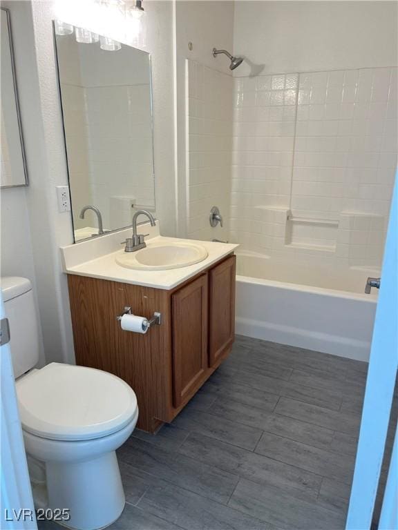 full bathroom featuring vanity, shower / washtub combination, and toilet