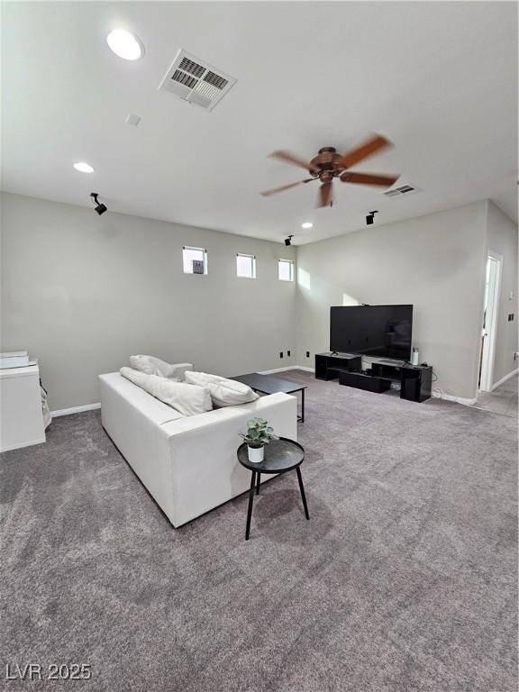 living room with ceiling fan and carpet