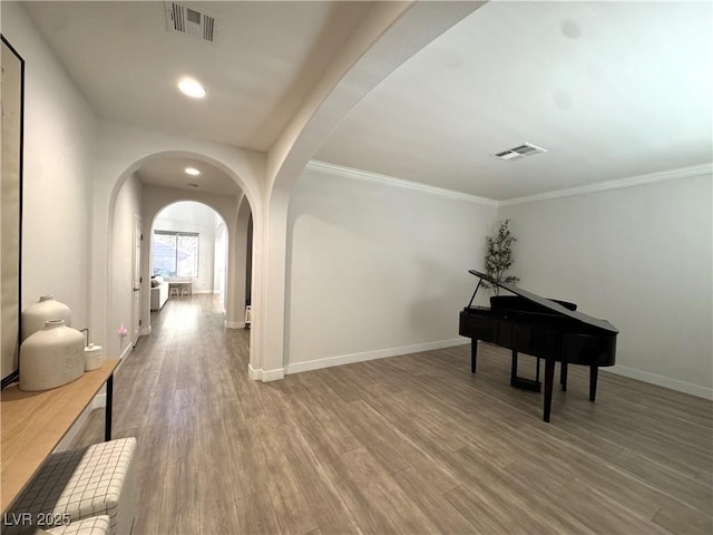 corridor featuring hardwood / wood-style flooring and ornamental molding