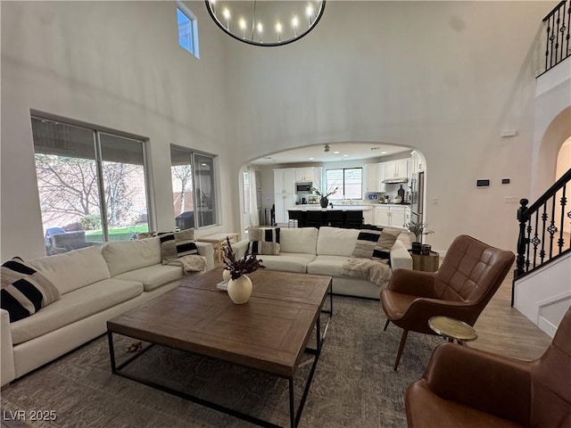 living room featuring a chandelier and a high ceiling