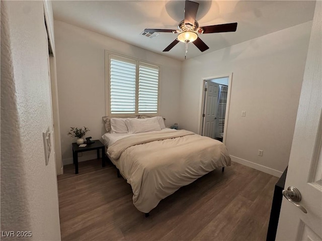 bedroom with dark hardwood / wood-style floors and ceiling fan