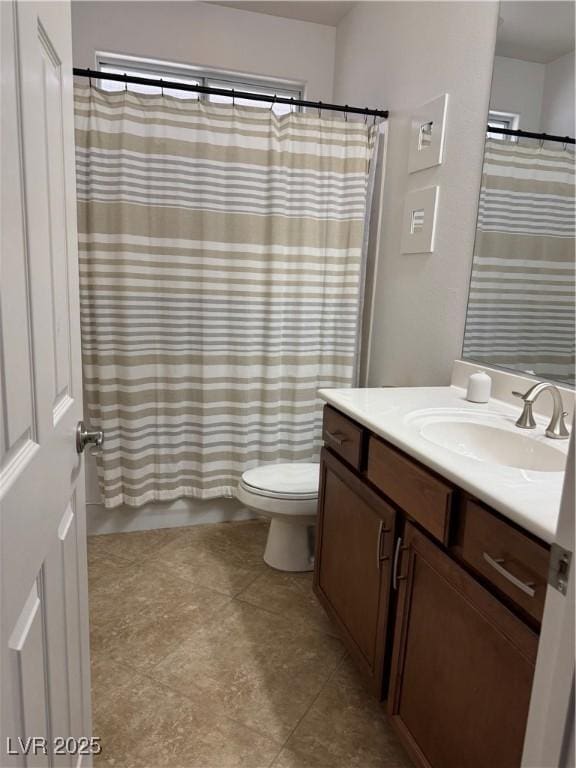 bathroom featuring vanity, toilet, and tile patterned flooring