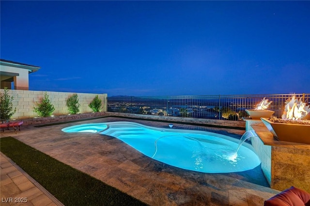 view of swimming pool featuring pool water feature, an outdoor fire pit, and a patio