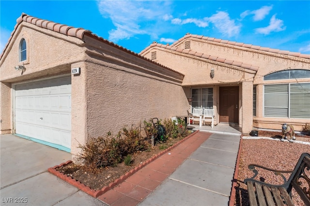 view of front of home featuring a porch and a garage