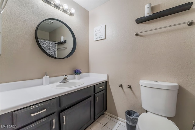 bathroom featuring tile patterned flooring, vanity, and toilet