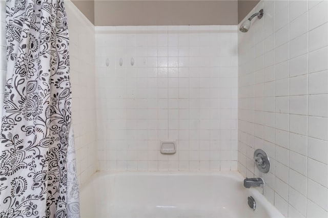 bathroom with shower / bath combo with shower curtain