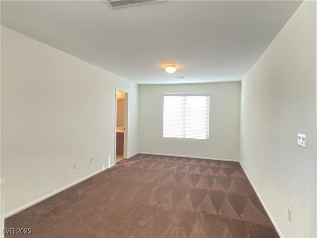 unfurnished room featuring dark colored carpet