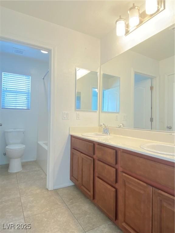 bathroom with vanity, tile patterned floors, and toilet