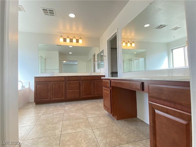 bathroom with tile patterned flooring, vanity, and plus walk in shower