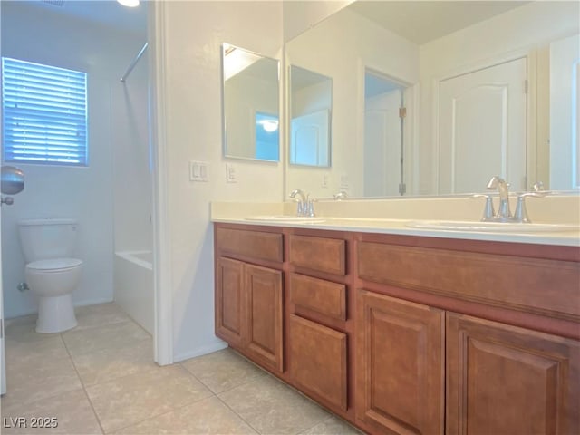 full bathroom with vanity, toilet,  shower combination, and tile patterned flooring