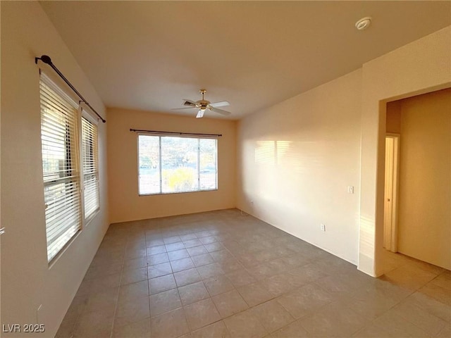 spare room with light tile patterned floors and ceiling fan