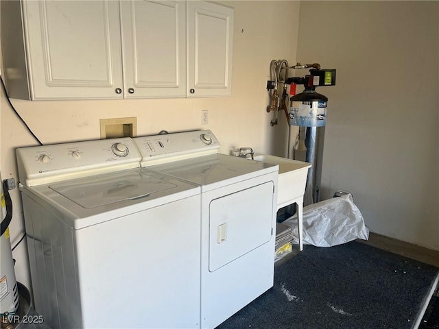 laundry area featuring separate washer and dryer and cabinets