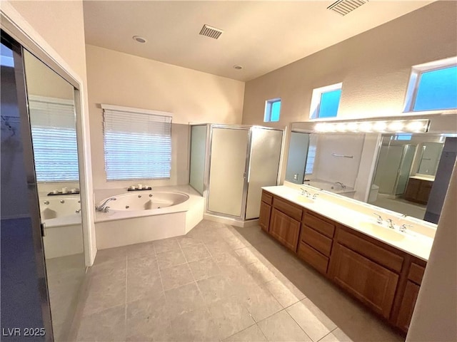 full bathroom with tile patterned flooring, vanity, shower with separate bathtub, and toilet