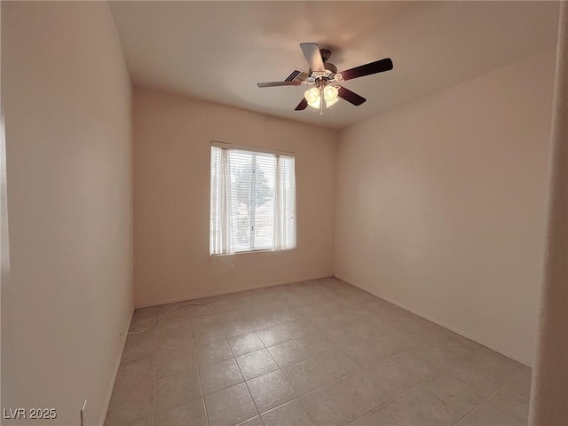 spare room with light tile patterned flooring and ceiling fan