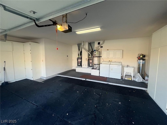 garage with a garage door opener, sink, heating unit, separate washer and dryer, and water heater