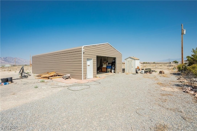 view of outbuilding with a mountain view and a garage