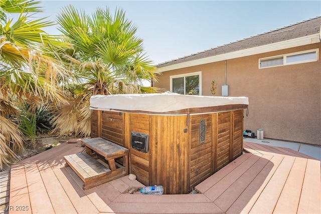 wooden deck with a hot tub