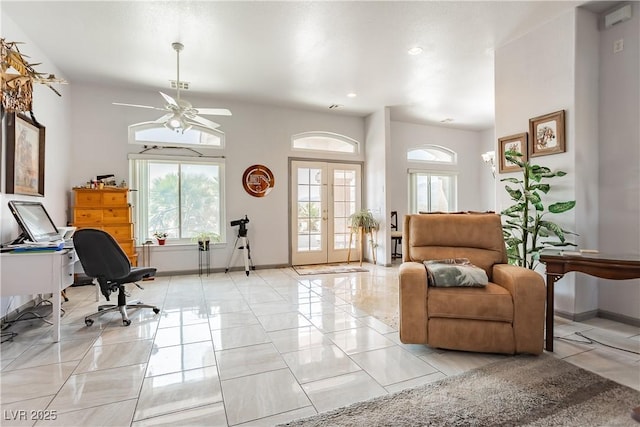 living area featuring french doors and ceiling fan