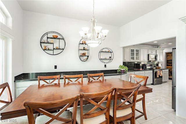 tiled dining space with a notable chandelier