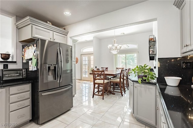 kitchen featuring tasteful backsplash, stainless steel fridge with ice dispenser, french doors, and gray cabinetry