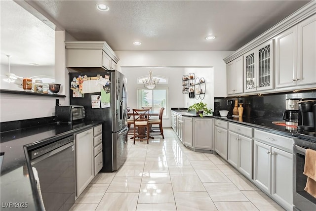 kitchen with tasteful backsplash, stainless steel appliances, a textured ceiling, and gray cabinetry