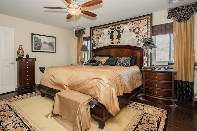 bedroom with multiple windows, hardwood / wood-style floors, and ceiling fan