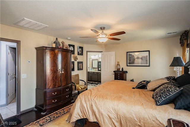 bedroom featuring ceiling fan, ensuite bathroom, and light hardwood / wood-style flooring