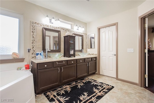 bathroom with vanity and a washtub