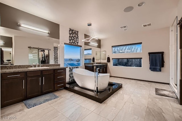 bathroom with vanity and a bathtub