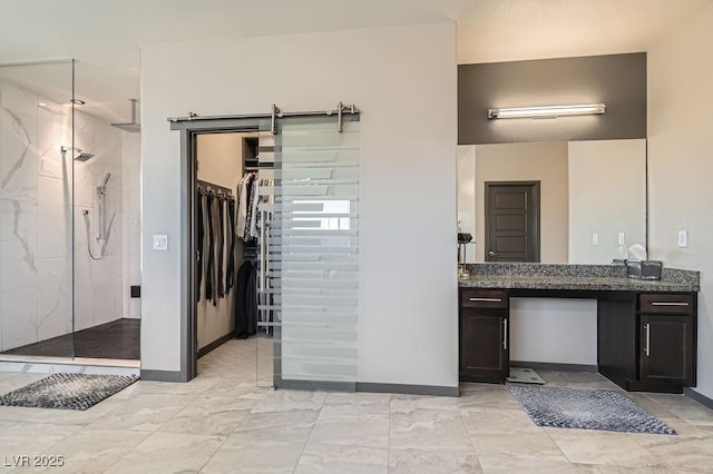 bathroom with vanity and a tile shower