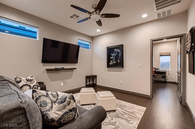 interior space featuring dark wood-type flooring, ceiling fan, and plenty of natural light