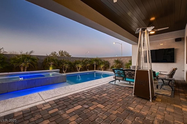 view of swimming pool featuring ceiling fan and a patio area